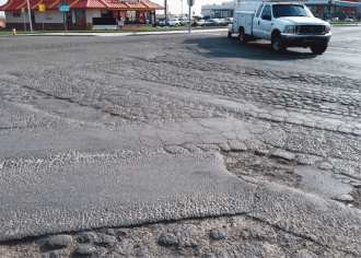 Example of worn asphalt ready for replacement along Howard Road in Westley, CA.